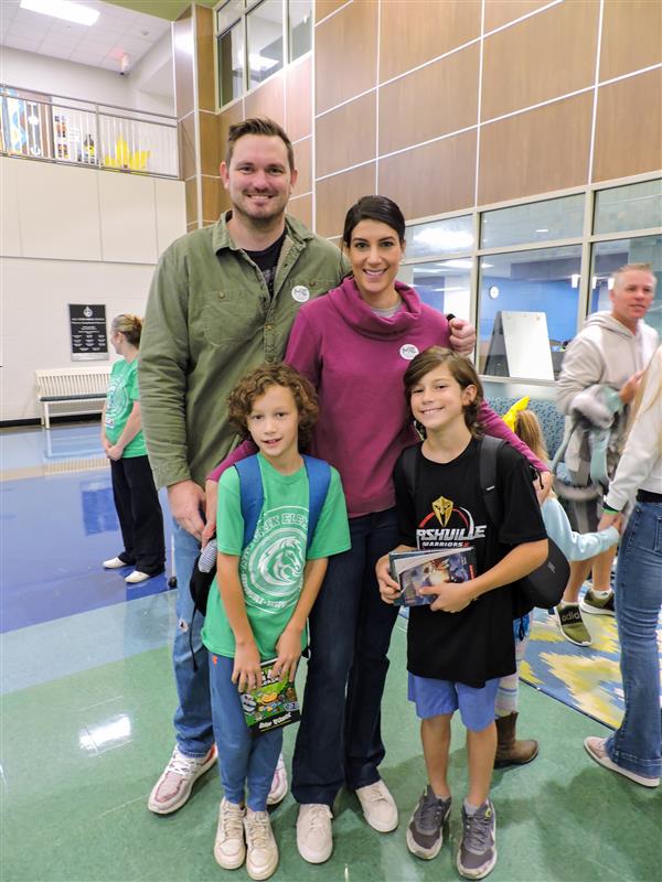 Students having pastries with their parents. 